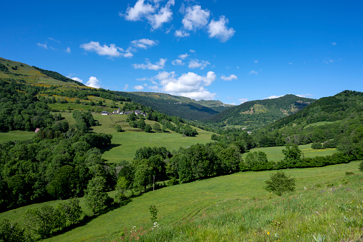 Rural panorama of Auvergne mountains made up of ancient volcano in spring greenery