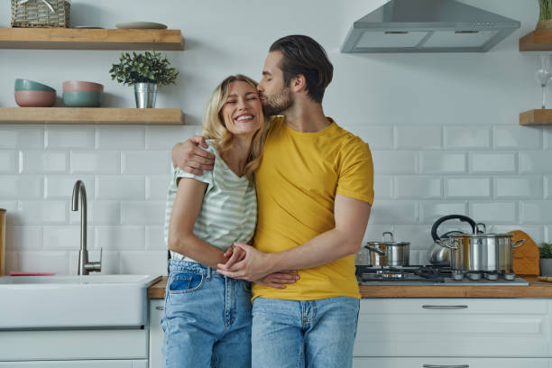 istock Cute young couple embracing and kissing 1402329893
