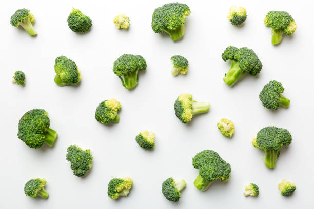 istock green fresh broccoli background close up on colored table. Vegetables for diet and healthy eating. Organic food 1402330783