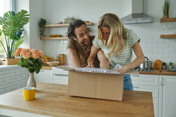 istock Playful young couple unpacking box 1402331002