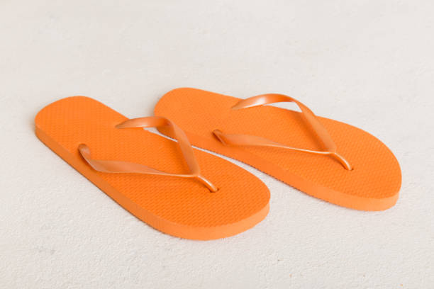 istock Beach accessories. Flip flops and starfish on colored background. Top view Mock up with copy space 1402331128
