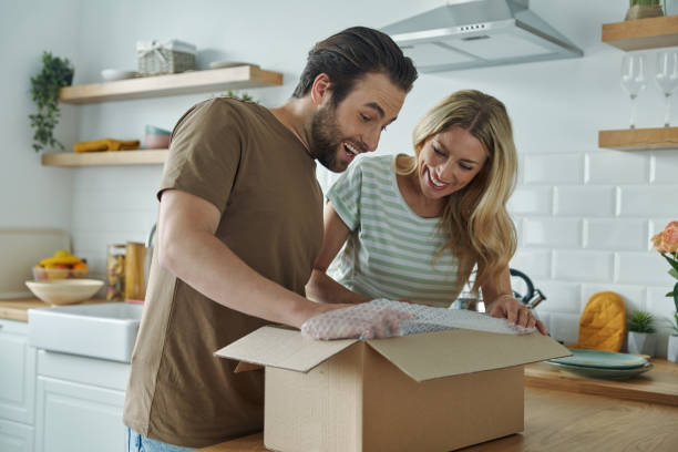 istock Young couple unpacking box and smiling 1402331159