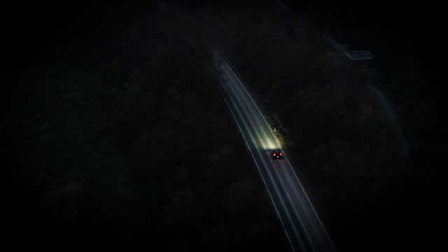 Car on country road at night - Aerial Shot