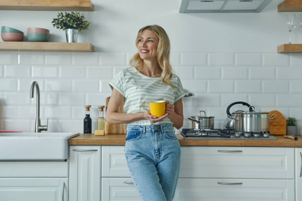 istock Cheerful young woman holding coffee cup 1402332220