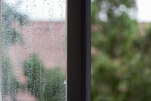 Landscape through the window in a rainy day.  River Miño , Portugal on the riverbank in front.