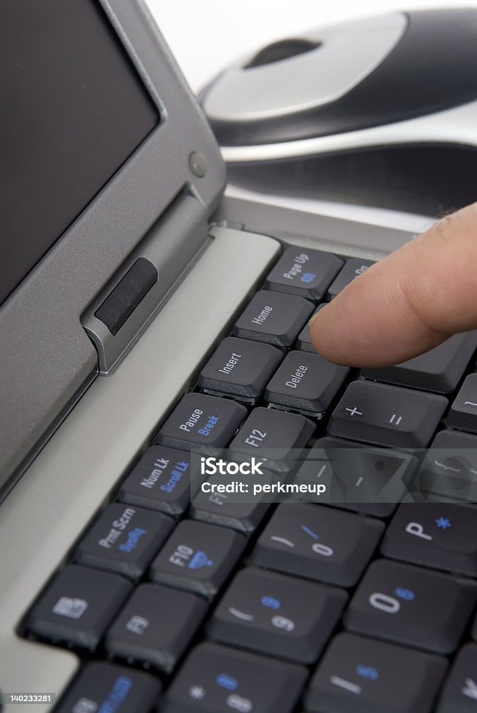 Delete A person pressing the delete key on a laptop Abstract Stock Photo