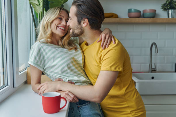 istock Beautiful young couple embracing 1402332855