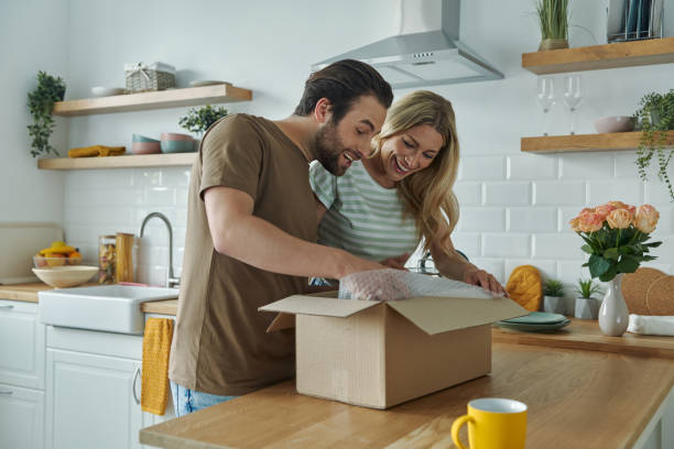 istock Happy young couple unpacking box and smiling 1402332867