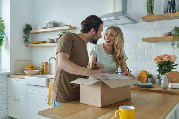 istock Beautiful young couple unpacking box and smiling 1402333217