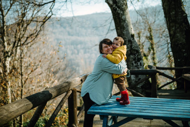 istock Young woman embraces little boy's son 1402336761