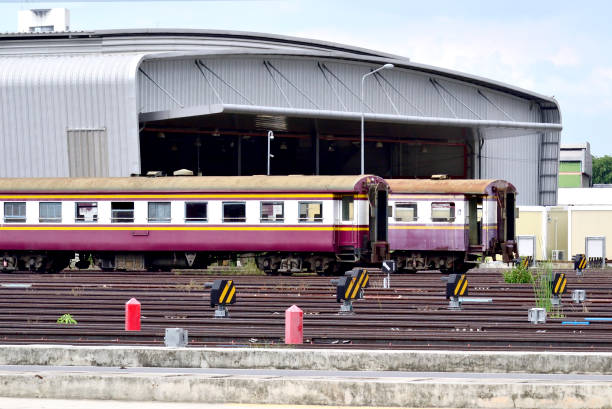 istock Two old passenger carriage parking beside new train depot. 1402337004