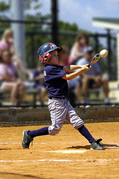 Young slugger A ten-year-old hits a home run in a youth league game batting sports activity stock pictures, royalty-free photos & images