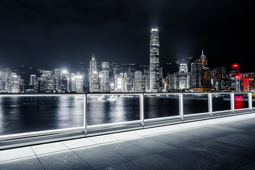 Empty brick platform with Hong Kong skyline in background at night