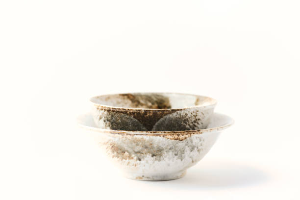 istock Traditional ceramic bowls on bright paper background. Soft focus. Close up. Copy space. 1402337975