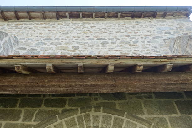 Canopy Wooden frame covered with flat terracotta tiles Monument built in granite stones