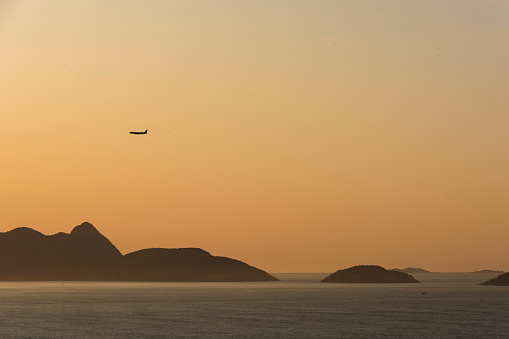 Rio de Janeiro, Brazil. Airplane flying over Guanabara Bay.