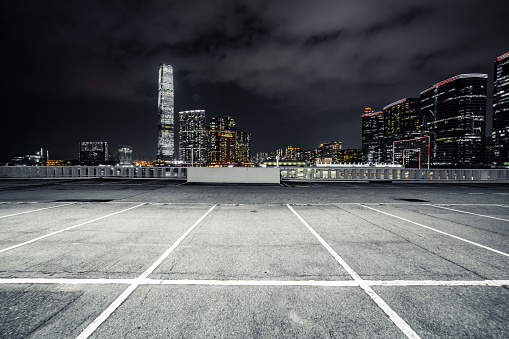 Empty brick platform with Hong Kong skyline in background at night