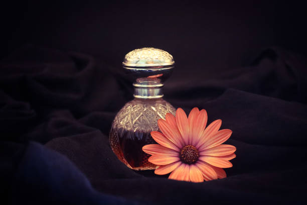 Vintage decorative small bottle of attar perfume or cologne on Black background