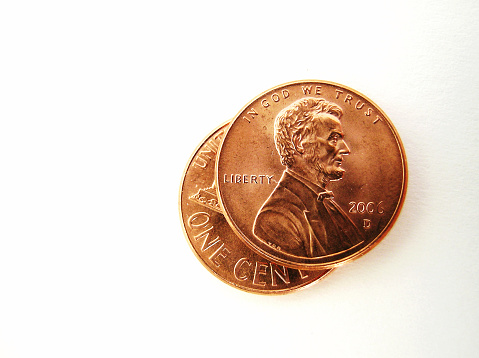 two american pennies on white background
