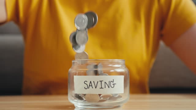 Slow motion Woman saving Money in Jar