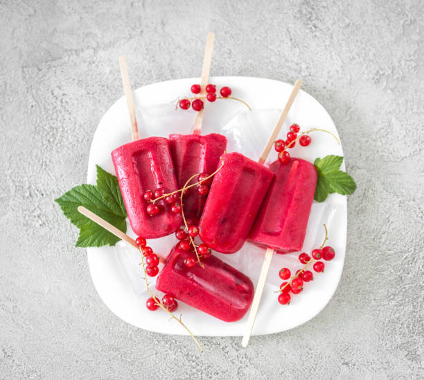 istock homemade ice-cream popsicles with red currant, topview 1402343862