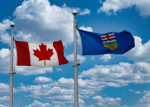 istock A Canadian Flag on a blue sky with some clouds 1402343880