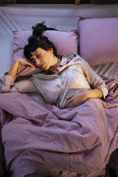 istock Woman Sleeping In Her Bed 1402344950