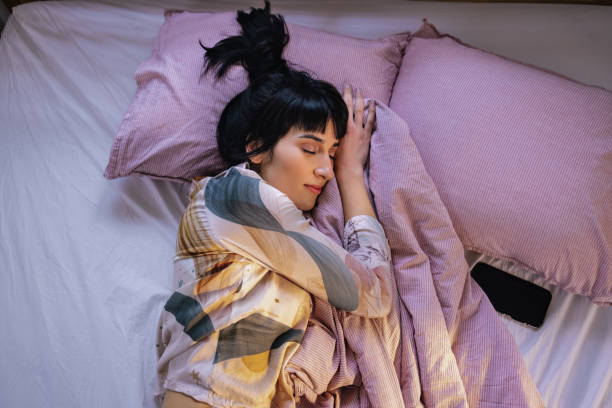 istock Woman Sleeping In Her Bed 1402344956