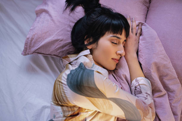 istock Woman Sleeping In Her Bed 1402344957