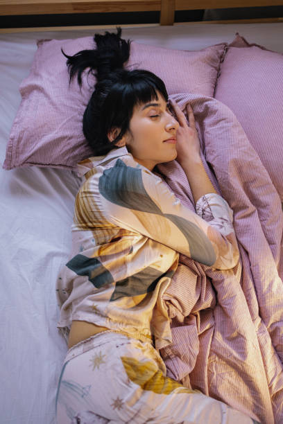 istock Woman Sleeping In Her Bed 1402344959