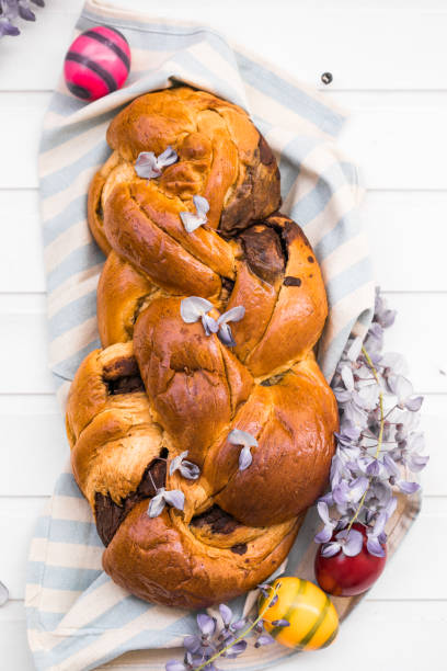 Tsoureki traditional baked Greek Easter sweet bread.  Easter time, springtime. Holiday food concept. Top view, flat lay, copy space stock photo