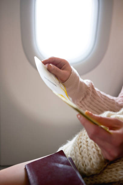 istock Woman reading the instructions on the plane 1402346154