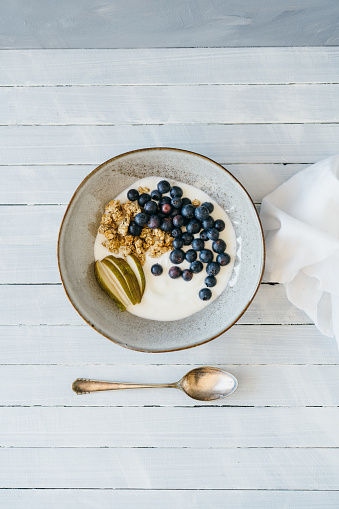 Granola with blueberries, pear and curd cheese