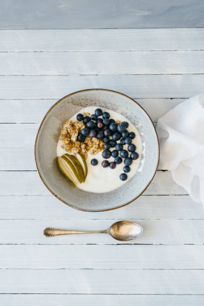 Granola with blueberries and pear Granola with blueberries, pear and curd cheese oat wheat oatmeal cereal plant stock pictures, royalty-free photos & images