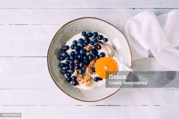 Granola With Blueberries And Tangerine Stock Photo - Download Image Now - Curd Cheese, Berry, Yogurt