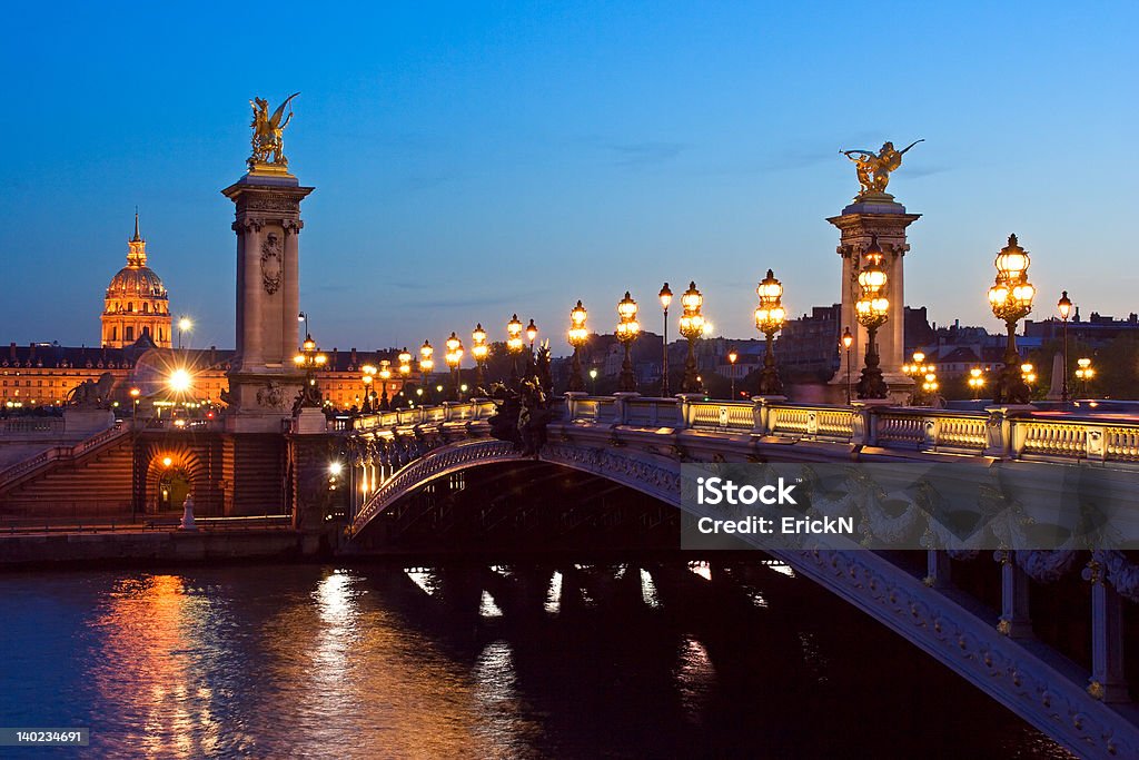 Alexander III Bridge The Alexander III bridge and the dome of the Invalides at night - Paris, France Night Stock Photo