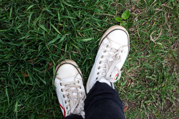 white shoes on green grass top view close up