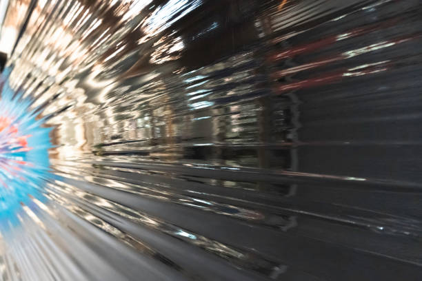 Black plastic wrap background. Crumpled wrinkled plastic cellophane. Reflecting light and shadow on creases and folds in plastic surface. Texture overlay effect template.