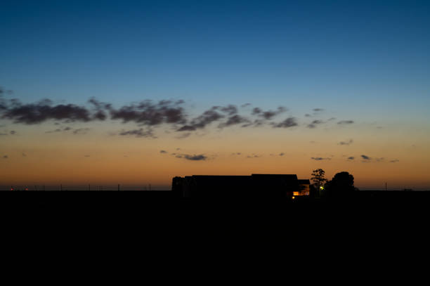 Beautiful evening scene during the periode of the shortest nights. Small clouds stand out darkly against the twilight sky and are a bit blurred by the long exposure.
