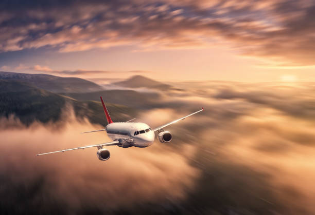 istock Airplane is flying above the clouds at sunset in summer 1402354200