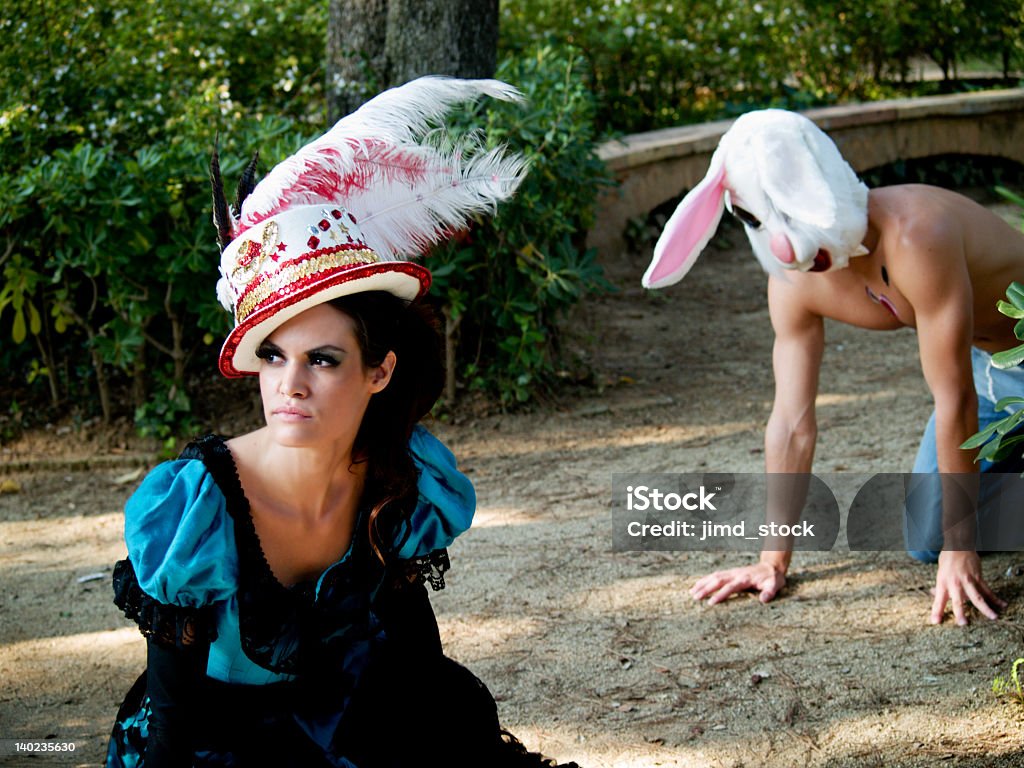 Fantasy Alice and the Rabbit Fantasy, Alice in Wonderland character is stalked by a costumed White Rabbit. Istockalypse, Barcelona, Spain. Alice in Wonderland - Fictional Character Stock Photo