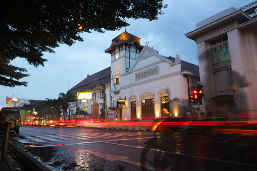 Bandung, West Java, Indonesia - January 10, 2022: N. I Escompto M.I.J building, one of historical building in Bandung. Landscape NIESCOMPTOMY building with light trails and dramatic sky in the evening
