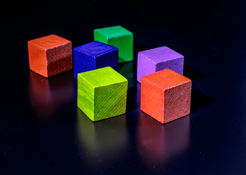 colorful wooden cubes isolated on black background