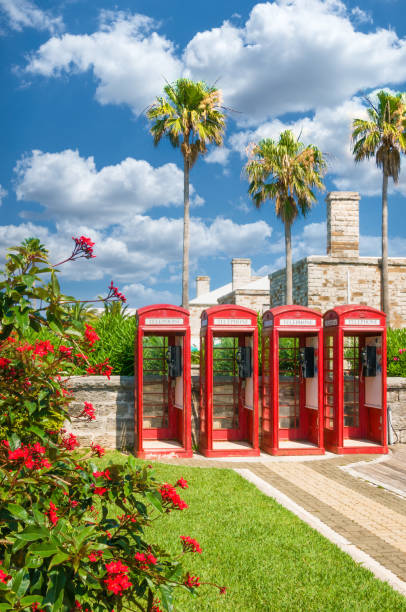 A row of four bright red telephone booths in the Royal Naval Dockyard of Bermuda