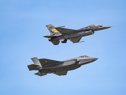 Hillsboro, Oregon, USA - May 22, 2022 : Maj. Kristin “Beo” Wolfe U.S. Air Force F-35A Lightning II Demo Team. Capt. Aimee “Rebel” Fiedler with the U.S. Air Force   F-16 Viper Demo Team. These two amazing jets are flying overhead. The Air Show in Hillsboro, Oregon is a very popular event each year. The theme for 2022 was “She Flies with her own wings.” All performers, pilots and announcers were women. Hillsboro is a suburb of the city of Portland, Oregon.