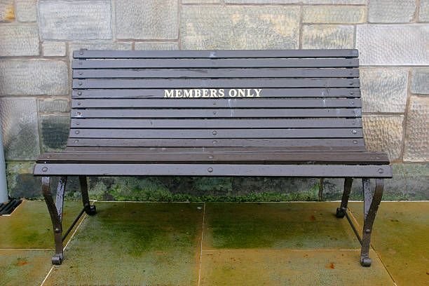 Brown painted bench with members only stock photo