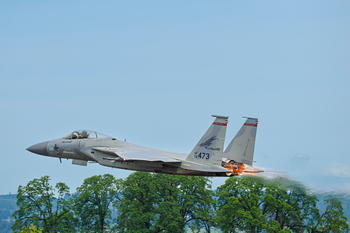 Hillsboro, Oregon, USA - May 22, 2022 : A low fly-by of an Oregon Air National Guard USAF F-15C Eagle. The Air Show in Hillsboro, Oregon is a very popular event each year. The theme for 2022 was “She Flies with her own wings.” All performers, pilots and announcers were women. Hillsboro is a suburb of the city of Portland, Oregon.