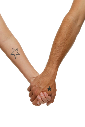 two people holding hands in front of a white background