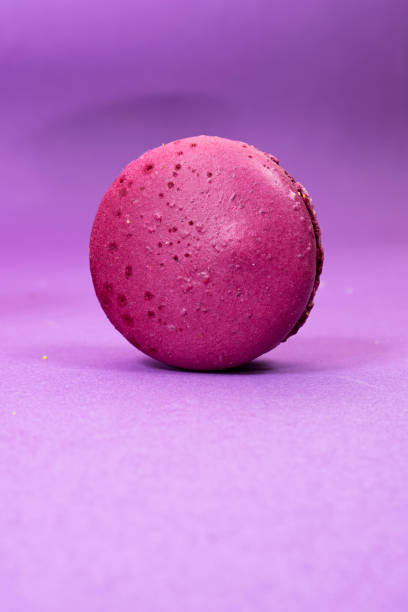 istock French purple Macaron Cookie isolated on purple background 1402360326