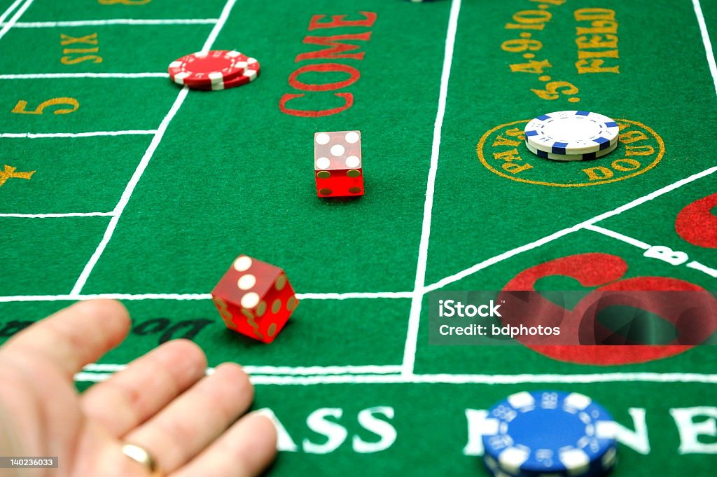 Throw the dice A craps player tosses his dice. 6-7 Years Stock Photo